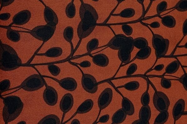 Patchwork stof - rust orange med bladmønster