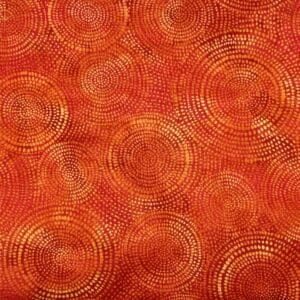 Patchwork stof - Orange med lidt gult i prikkede ringe