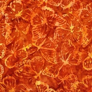 Patchwork stof - Brændt orange med sommerfugle. Batik